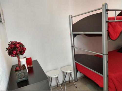 a bedroom with a bunk bed and a table and stools at Residence Las Trojes Cdmx in Mexico City