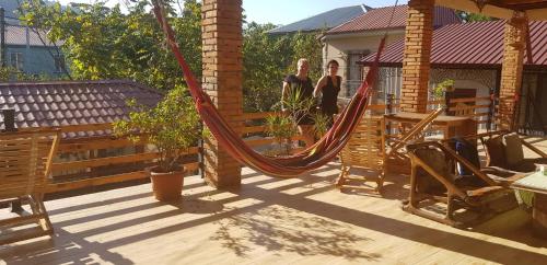 two women standing on a deck with a hammock at Batumi Wonderland in Batumi