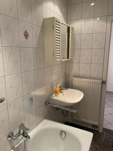 a bathroom with a sink and a bath tub at Ferienhof Kröger in Bielefeld