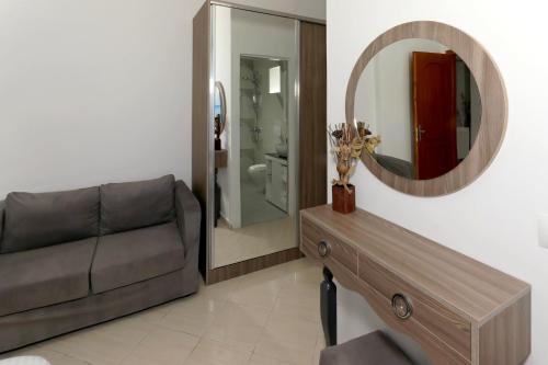 a living room with a couch and a mirror at Villa Doka in Sarandë