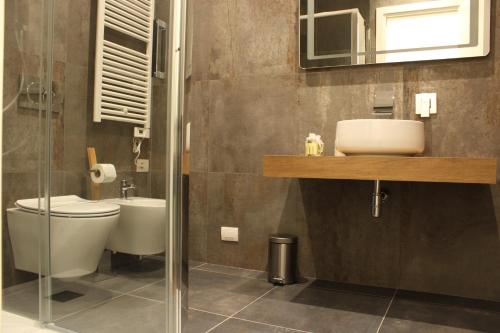 a bathroom with a toilet and a sink and a mirror at Moro 34 in Bari
