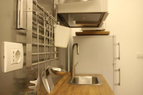 a kitchen with a counter with a sink and a refrigerator at Moro 34 in Bari