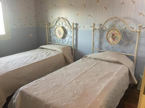 מיטה או מיטות בחדר ב-Casa vacanza