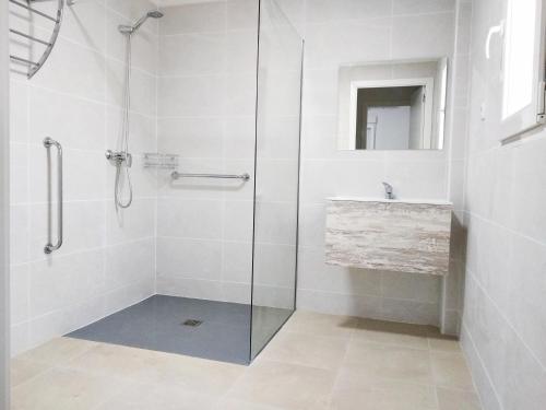 a bathroom with a glass shower and a sink at GOLDEN TOWER pensión Auto Check-in in Gandía