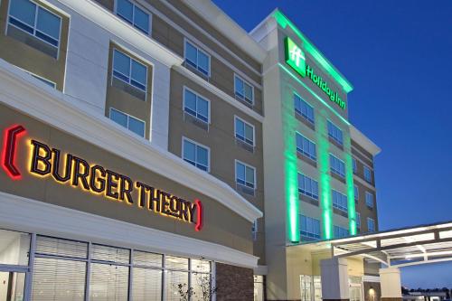 a hotel building with a burger them sign on it at Holiday Inn Hattiesburg - North by IHG in Hattiesburg
