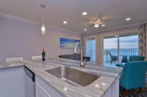 a kitchen with a sink and a view of the ocean at La Bella Vita - Luxury Waterfront Condo-Free WIFI-Heated Pool in Tampa