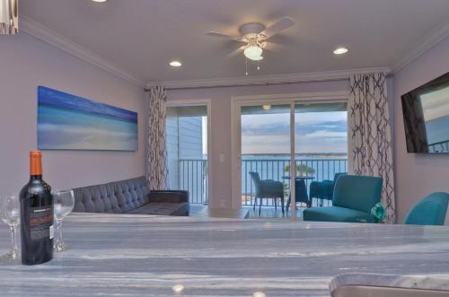 a bottle of wine sitting on a table in a living room at 410-Gorgeous Views, Waterfront, WIFI, Pool and close to BUCS Stadium in Tampa