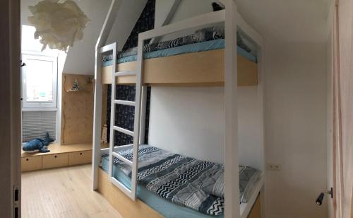 a bedroom with two bunk beds in a room at Poranna Bryza in Mechelinki