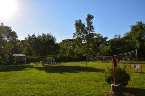 a park with a volleyball net in the grass at Nuevas Cabañas Del Sol in San Lorenzo