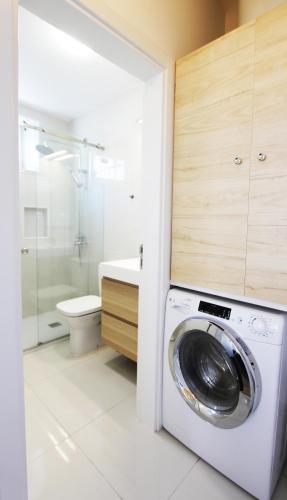 a washing machine in a bathroom with a toilet at Casas S Cristovao in Évora