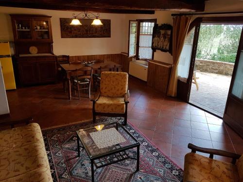 a living room with a table and a dining room at Agriturismo Il Poggiarello in Siena