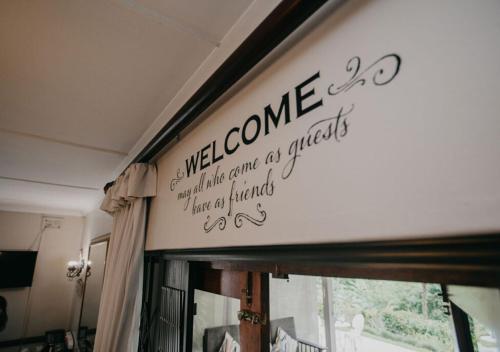 a welcome sign on a wall above a window at Sylvern Bed and Breakfast in Durban