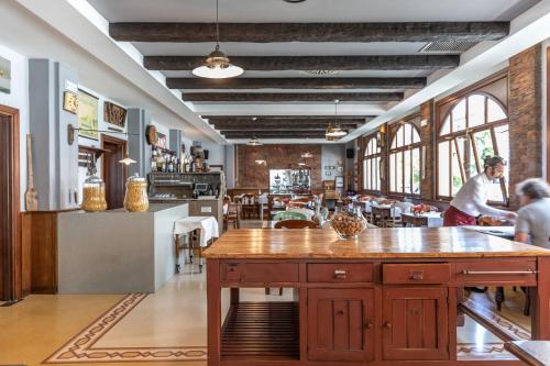 a restaurant with a large table in the middle of a room at Mathis in Fiorenzuola dʼArda