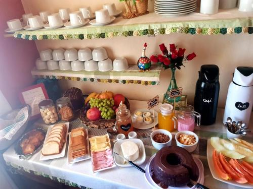 una mesa con alimentos para el desayuno y huevos. en Pousada Sayonara en Atibaia