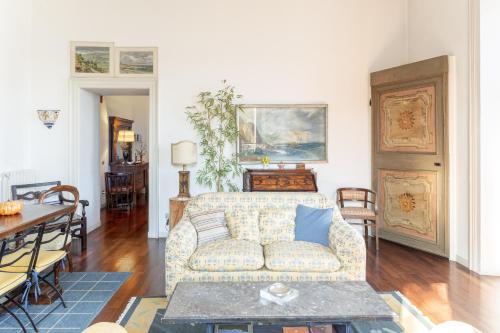 a living room with a couch and a table at Villa Niobe - Exclusive Lakefront Apartment With Private Beach in Stresa