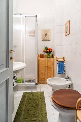 a bathroom with a toilet and a sink and a shower at Villa Niobe - Exclusive Lakefront Apartment With Private Beach in Stresa