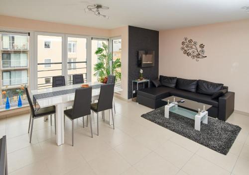 a living room with a black couch and a table at Margaux in De Panne