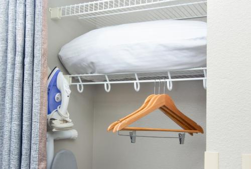 a closet with a bed and a rack with a bed at Belltown Inn in Seattle