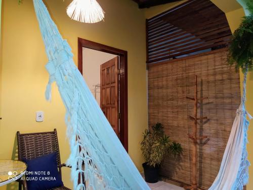 a room with a bed with a blue net at Pousada João Maria in Trancoso
