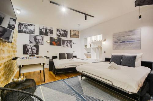 a bedroom with two beds and a desk in it at Amazing 10bed in the heart of le marais and suprises... in Paris