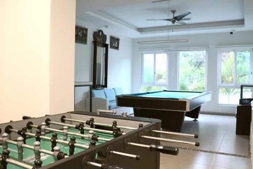 a living room with a pool table and a bill at LYDMAR BOUTIQUE HOTEL in Zihuatanejo