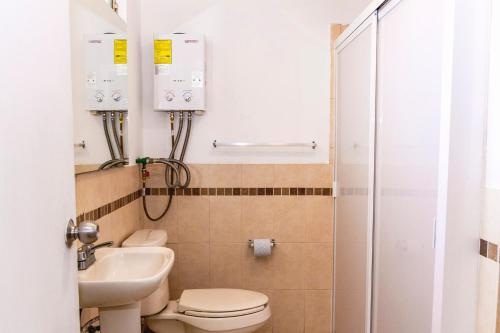 a bathroom with a toilet and a sink and a shower at Gdl Collection for families in Guadalajara