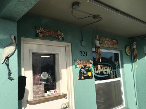 a room with a door and a bird on the wall at Immokalee Inn in Immokalee