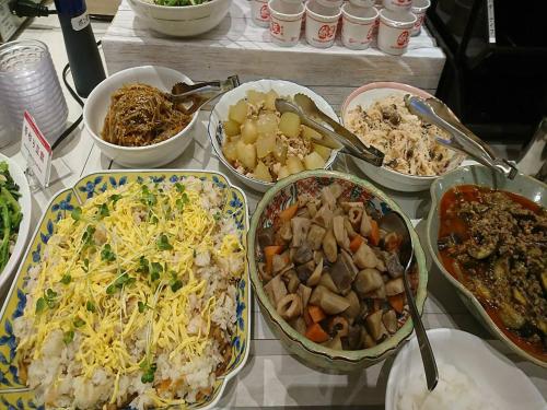 a table topped with bowls of different types of food at Hotel Kuretakeso Hiroshima Otemachi in Hiroshima