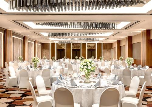 a ballroom with white tables and white chairs at Marco Polo Plaza Cebu in Cebu City
