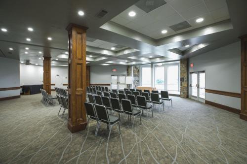 a large room with chairs and tables and windows at The Ridges Resort on Lake Chatuge in Young Harris