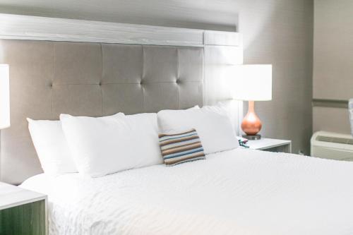 a bedroom with a white bed with two lamps at The Ridges Resort on Lake Chatuge in Young Harris