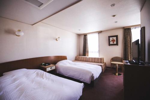 Llit o llits en una habitació de Hotel Kajiwara