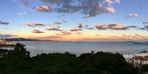 a view of the ocean with a cloudy sky at SOU東恩納 in Uruma