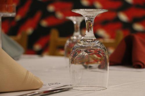 a wine glass sitting on top of a table at Brickyard Retreat at Mutianyu Great Wall Adjoin to Mutianyu Great Wall - Room with the View of Great Wall - Chinese massage experience - Vehicle Shuttle Service - International Catering - SPA& Nail Beauty Facilities in Huairou