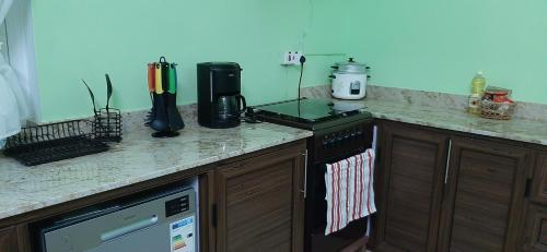 a kitchen with a stove and a counter top at Casa Accacias in Port Louis