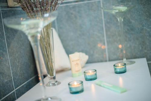 a table with candles and vases on a counter at Apartment Studio Lara in Rovinj