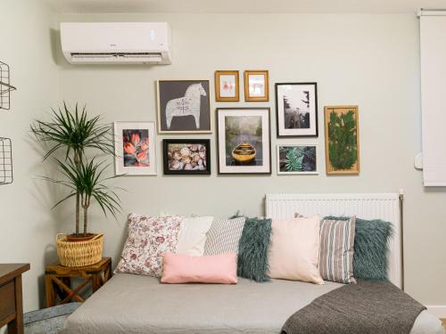 a living room with a couch with pictures on the wall at Ma Maison Ioannina in Ioannina