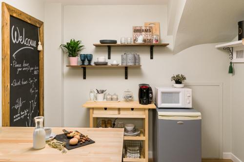 a small kitchen with a table and a microwave at Ma Maison Ioannina in Ioannina