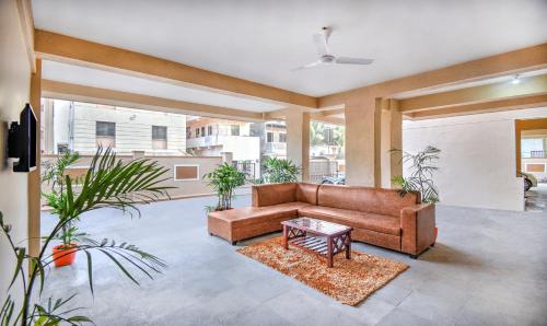 a living room with a couch and a table at Treebo Sayaji Residency in Pune