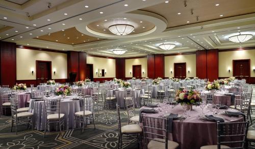 a ballroom with tables and chairs in a room at Omni Houston Hotel in Houston