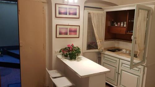 a small kitchen with a counter and flowers on it at Casa Lulù in Minori