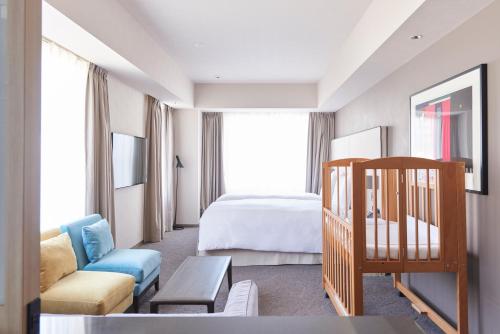 a hotel room with a bedroom and a bed at NOHGA HOTEL UENO TOKYO in Tokyo