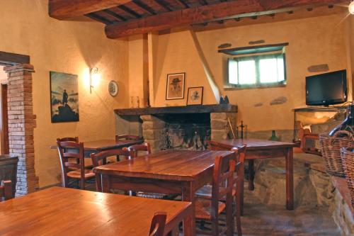 um restaurante com mesas de madeira e uma lareira em Podere Pian De' Cortini em Serravalle