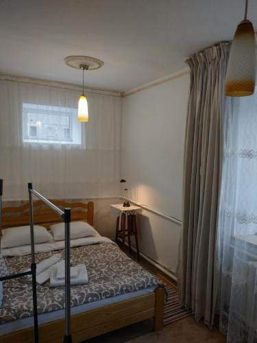 1 dormitorio con cama y ventana en Гостьовий дім у Почаєві, en Pochaiv