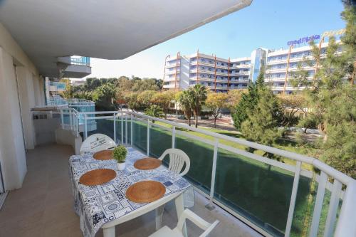a balcony with a table and chairs and a view of a building at COSTA DAURADA APARTAMENTS - Larimar in Salou
