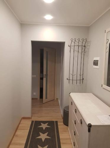 a room with a kitchen with a rug on the floor at Cosy home 10 min from city center in Tallinn