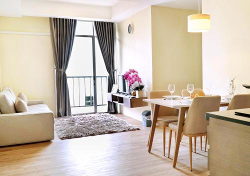 a living room with a table and chairs and a dining room at Bandara City Apartemen- 2BR in Tangerang