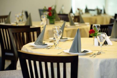 a table with plates and glasses with sailboats on it at Best Western Plus Mahboula in Kuwait
