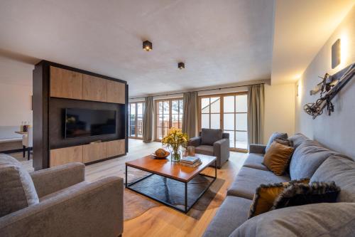 a living room with a couch and a table at Brunnenhof Luxury Apartments in Lech am Arlberg