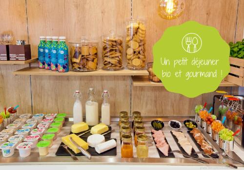 a counter with some food and drinks on it at Residhome Neuilly Bords De Marne in Neuilly-Plaisance